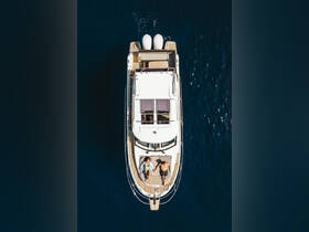 A couple enjoys a romantic moment on the deck of a yacht, soaking up the sun and the serene blue waters — perfect for a getaway or special occasion.