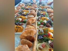 A beautifully arranged spread of gourmet food and snacks on a boat, perfect for catering during a day on the water.