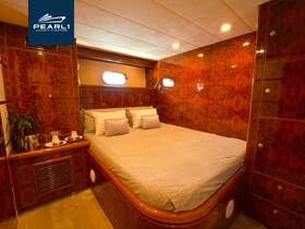 Luxurious interior cabin of a yacht featuring a spacious bed and elegant decor, perfect for relaxation during your boating adventures.