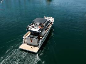 A stunning aerial view of a yacht cruising through clear waters, showcasing its sleek design and elegant features.