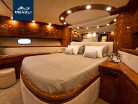 Luxurious interior of a yacht cabin featuring a spacious bed and elegant wooden finishes, perfect for relaxation on the water.
