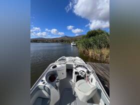 A well-equipped boat interior featuring a spacious helm and comfortable seating, perfect for a day on the water.