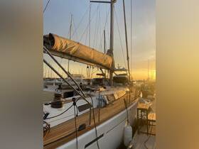 A stunning sunset view of a yacht docked at the marina, showcasing its sleek design and wooden deck — perfect for evening cruises.