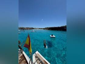 A person dives into the crystal-clear turquoise waters from a boat, capturing the essence of summer fun and adventure on the water.
