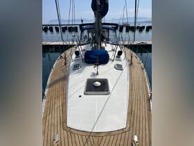 A clear view of a yacht docked at the marina, showcasing its sleek design and wooden deck, perfect for sailing enthusiasts.