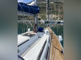 A detailed view of a sailboat docked in a serene marina, showcasing its sleek design and surrounding natural beauty.