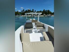 Interior view of a spacious boat cabin featuring comfortable seating, perfect for relaxing during a day on the water.