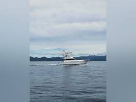 A sleek speedboat navigates through calm waters, showcasing its impressive design against a backdrop of distant mountains — perfect for fishing trips or leisurely cruises.