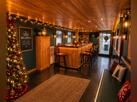 The cozy interior of the 'Sea Love II' features a beautifully designed bar area, perfect for enjoying drinks and good vibes while on the water.