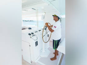 A captain navigates the helm of a boat, showcasing the interior control area equipped for smooth sailing. Ideal for understanding the boating experience.
