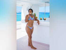 A woman enjoys a refreshing cocktail while relaxing on a boat, showcasing the perfect blend of leisure and fun on the water.