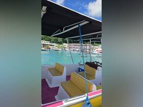 Interior view of a boat featuring comfortable seating and a vibrant color scheme, perfect for relaxing on the water.