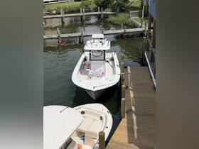 A clear view of a fishing boat docked at a marina, showcasing its sleek design and readiness for a day on the water.