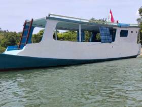 A side view of a colorful boat docked in calm waters, showcasing its unique structure and design, perfect for exploring coastal areas.
