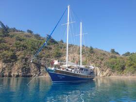 A stunning side view of the Xanthos III yacht docked in tranquil waters, surrounded by lush greenery — perfect for serene sailing adventures.