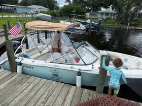 A family prepares to board their boat at the dock, with a child eagerly exploring the surroundings — a perfect moment for family boating adventures.