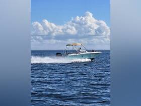 A speedboat cruises through the sparkling waters of Key West, showcasing the thrill of boating adventures on the open sea.