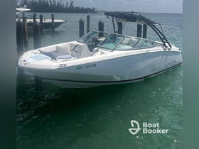 A sleek speedboat docked in calm waters, showcasing its modern design and inviting seating area — perfect for a day out on the water.