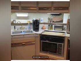 A well-equipped kitchen inside a boat featuring a sink, coffee maker, and stove, perfect for preparing meals while on the water.