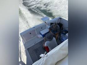 Two friends enjoy a fishing trip aboard a boat, surrounded by the excitement of the open water — perfect for a day of relaxation and camaraderie.
