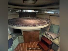 Cozy cabin interior featuring a circular bed and seating area, perfect for relaxation on a boat.