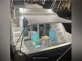 A cozy interior view of a boat's lounge area featuring comfortable seating and a small table, perfect for relaxing on the water.