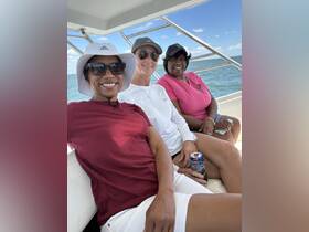 A group of friends enjoys a relaxing day on the boat, capturing joyful moments together on the water.