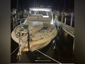 A beautifully lit yacht docked at night, showcasing its elegant design and surroundings in the marina.