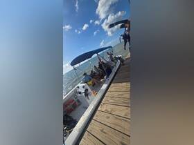 A lively group enjoys their time aboard a boat, ready for an adventure on the water. Perfect for family outings or group excursions.