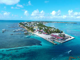 A stunning aerial view of a vibrant island community surrounded by crystal-clear waters, showcasing the perfect blend of nature and local culture.