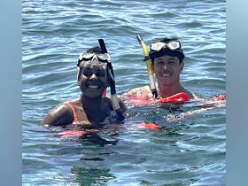 Two snorkelers enjoy a vibrant underwater adventure, showcasing the excitement of swimming and exploring marine life.