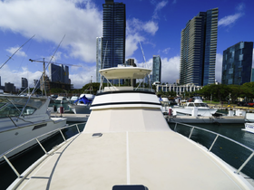A stunning view of a yacht docked in a marina, surrounded by modern skyscrapers, showcasing the perfect blend of luxury and urban scenery.