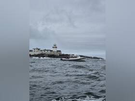 A boat navigates the choppy waters near a historic lighthouse, showcasing a scenic maritime adventure.