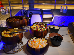 A beautifully arranged buffet featuring a variety of fresh salads and fruits, perfect for onboard dining experiences.