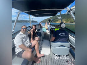 A cheerful group enjoys a day on the water aboard a boat in Knysna, creating unforgettable memories with family and friends.