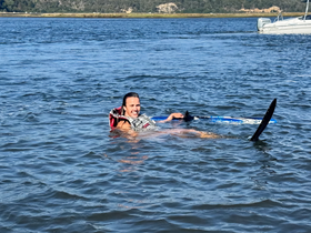 A person enjoys water skiing in a scenic setting, showcasing the thrill of outdoor water activities.