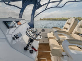 A sleek and modern helm area inside a boat, featuring comfortable seating and advanced navigation equipment, perfect for a smooth sailing experience.