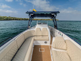 A spacious and elegantly designed interior of a boat featuring comfortable seating and a well-equipped helm, perfect for relaxing on the water.