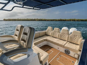 Interior view of a luxurious boat seating area, featuring plush seating and a stylish helm, perfect for comfortable cruising on the water.