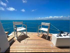 A serene view of the seating area on a yacht, featuring stylish chairs and a beautiful ocean backdrop — perfect for relaxation and enjoying the sea breeze.
