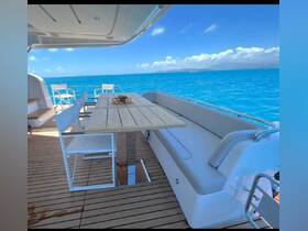 A beautifully designed dining area on a yacht, featuring a wooden table and comfortable seating, perfect for enjoying meals while taking in stunning ocean views.