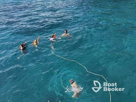 A group enjoys snorkeling in crystal-clear waters, showcasing the fun and adventure of underwater exploration.