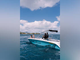 A couple enjoys a day on the water aboard the 'Sun Chaser 2,' surrounded by stunning scenery and good company — perfect for memorable boating experiences.