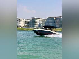 A sleek speedboat glides through the turquoise waters, showcasing an exciting day on the water against a backdrop of modern architecture.