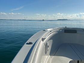 A serene view from the front of a speedboat, showcasing calm waters and distant islands — perfect for a day of exploration on the open sea.