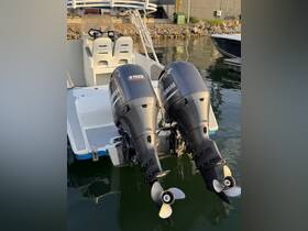 Close-up view of twin Yamaha outboard motors on a boat, showcasing the vessel's powerful setup at the dock.