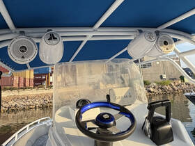 A detailed view of the helm and console area inside a boat, showcasing modern audio equipment and navigation tools, perfect for enhancing the boating experience.