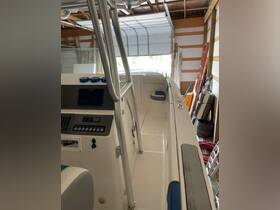 An interior view of a boat's helm and console area, showcasing the sleek design and features ideal for navigation and comfort.