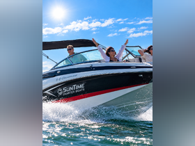 A joyful group enjoys a thrilling ride on a Crownline charter boat, celebrating the beauty of the open water under a bright sun.