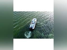 Aerial view of a sleek speedboat cruising through shimmering waters, showcasing the perfect vessel for thrilling adventures on the open sea.